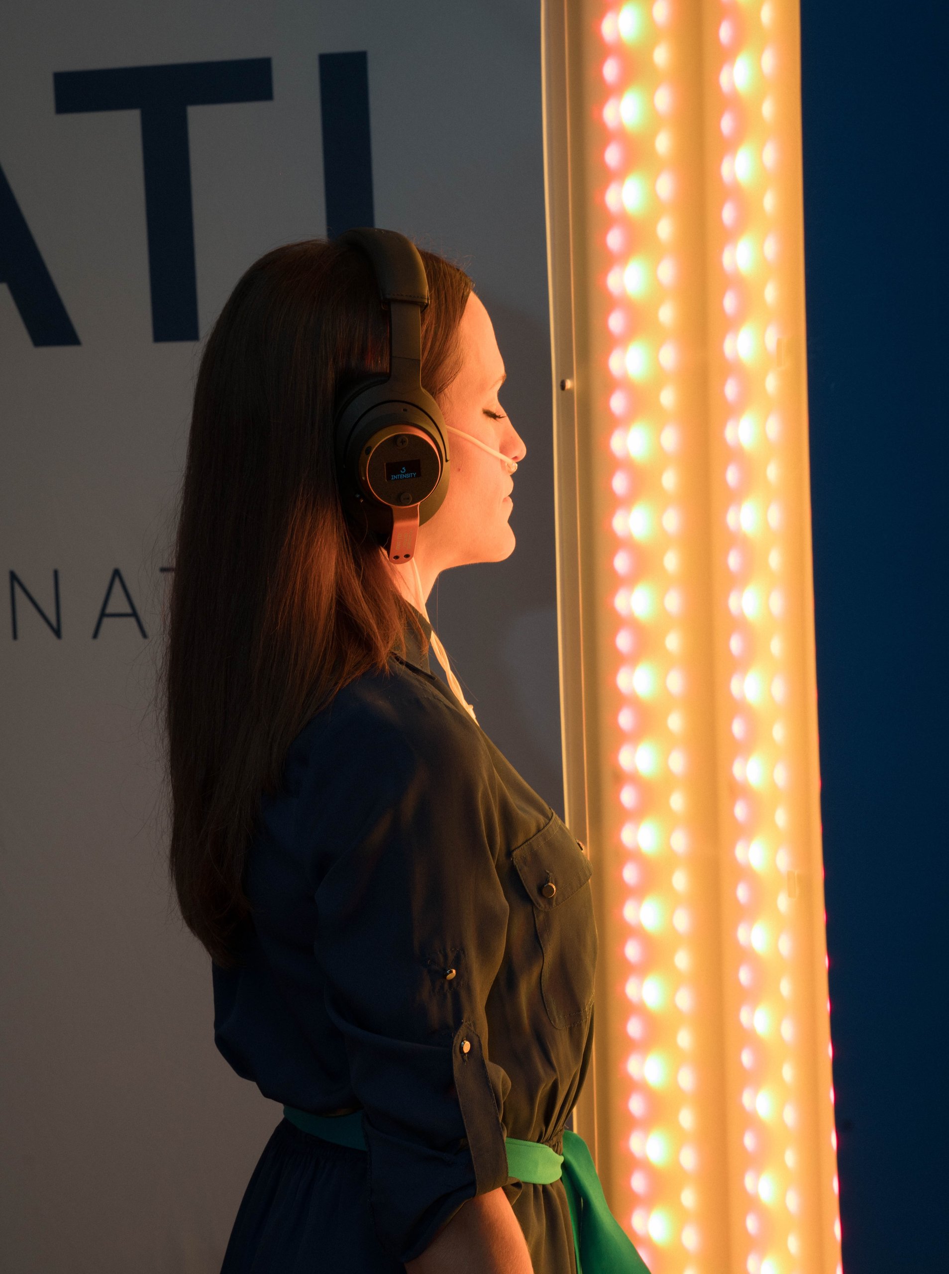 An attendee at a light-and-sound wellness station at the Healthspan Summit